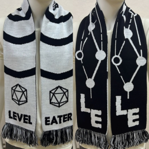 Sample of the black-and-white knit scarf with Level Eater designs.